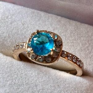 Gold Ring with Blue Gemstone and Clear Accents